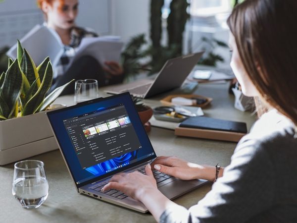 Woman sitting at a table working on a laptop