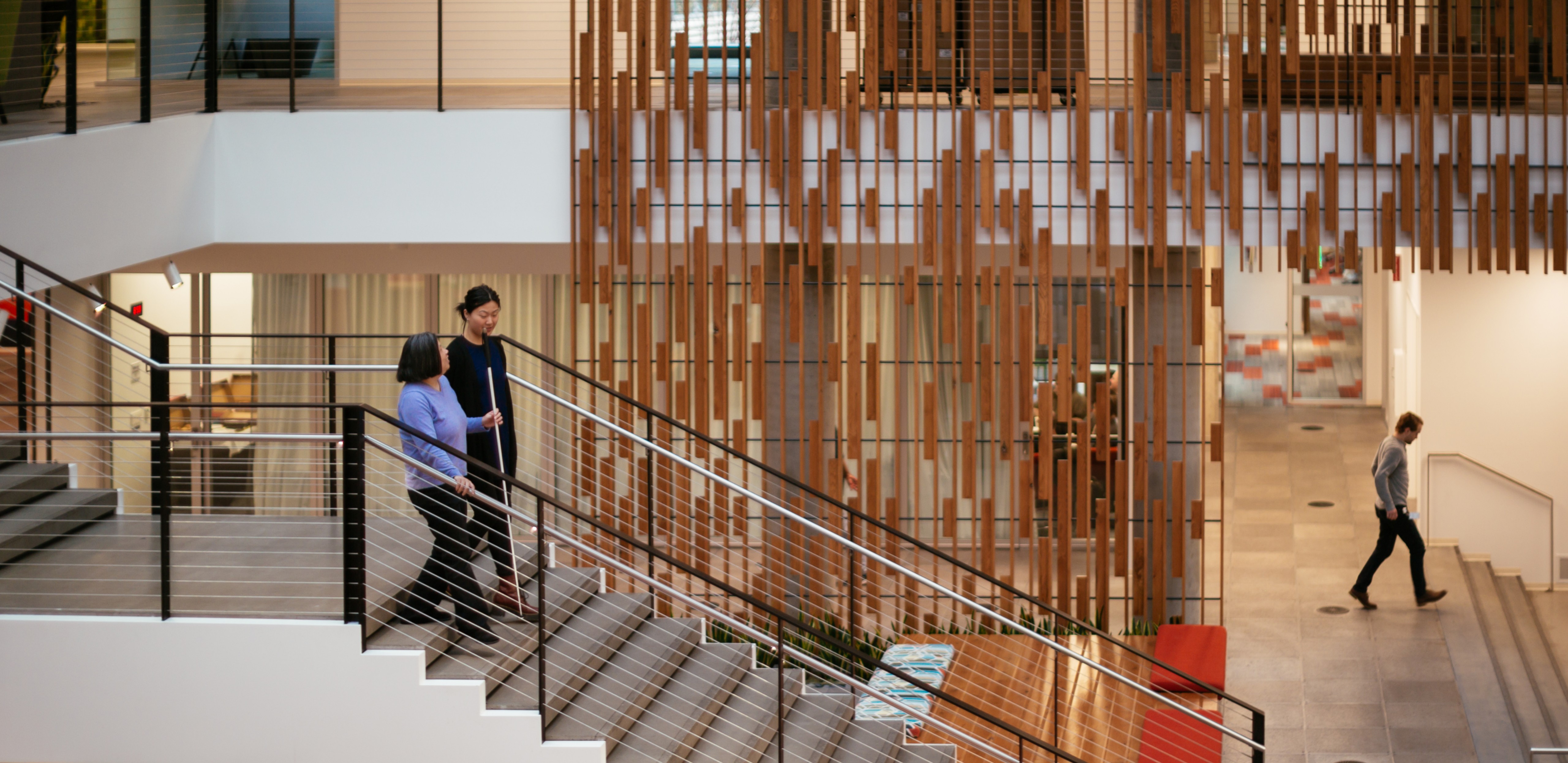 Two people walking down a staircase
