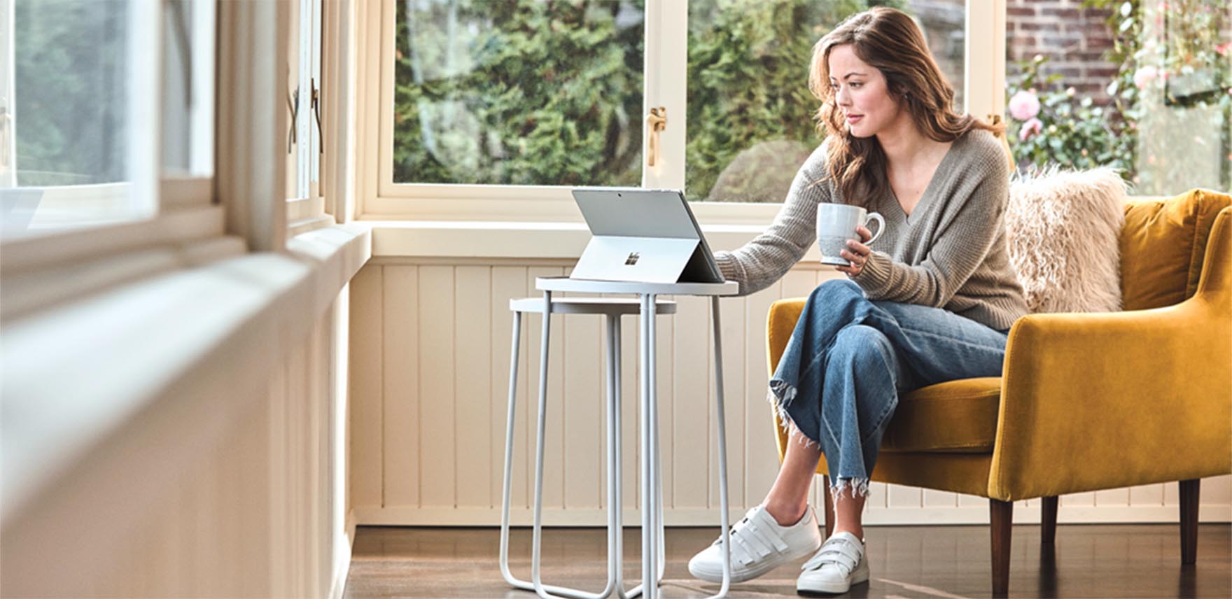 Woman working at home on a mobile device