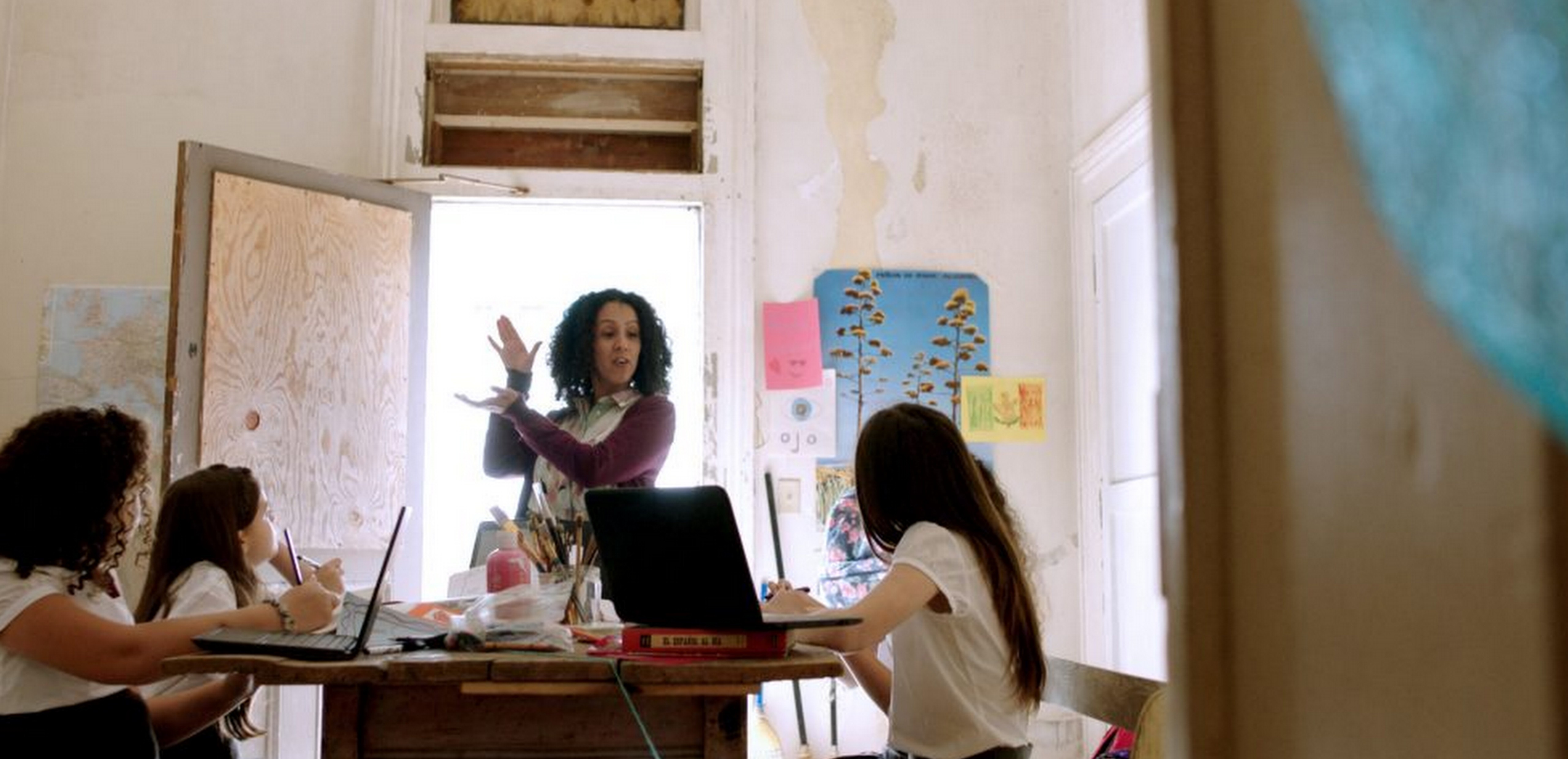 Teacher in a classroom with students who are sitting down