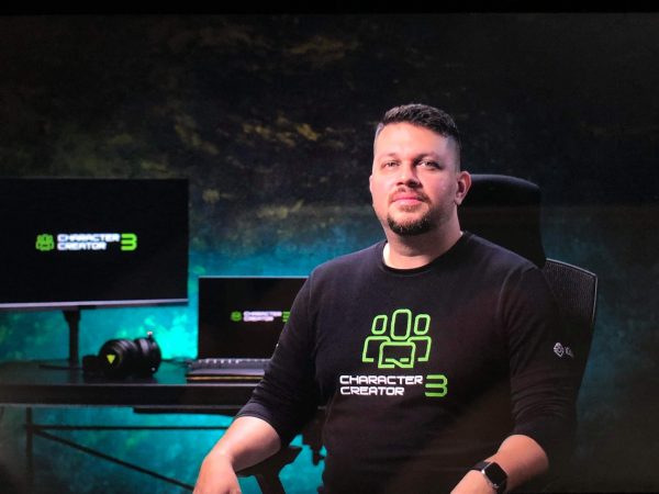 Enoc Burgos sitting in front of his Razer station