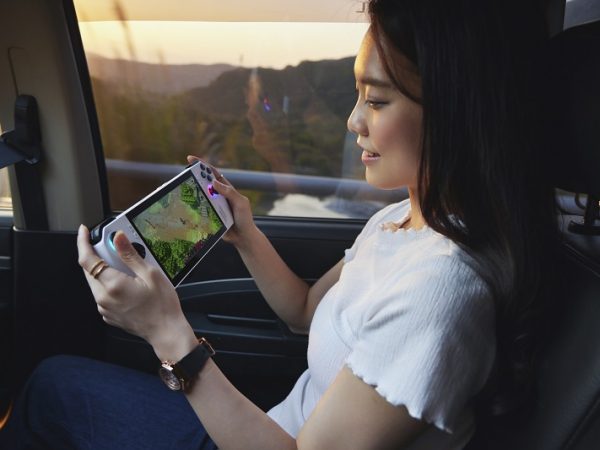 Woman sitting with handheld gaming console