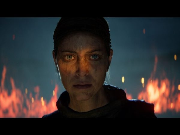 Woman staring directly at camera with flames in background