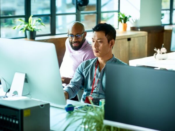 Two colleagues collaborating at a desk
