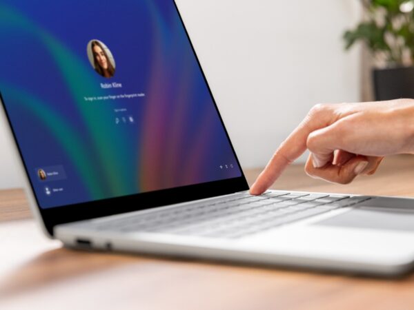 A person securely signing into their Surface Laptop with biometric authentication.