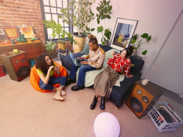 Three people lounging in a living room.