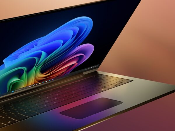 Close up of a Windows laptop open and floating mid-screen with Bloom wallpaper on screen